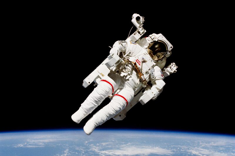 Astronaut Bruce McCandless II flies untethered above Earth using the Manned Maneuvering Unit during Space Shuttle mission STS-41-B in February 1984.